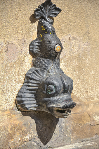 Olite, Spain - Aug 31, 2022: Fish shaped fountain in the Medieval town of Olite, Navarre, Spain