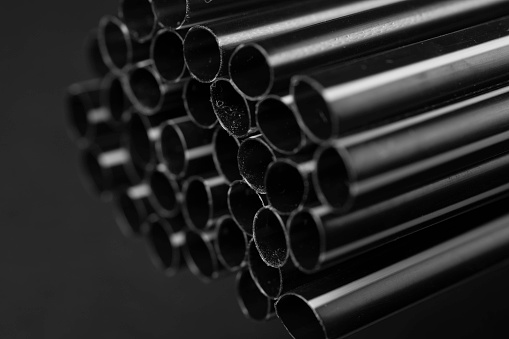 Black polypropylene pipes close up.
