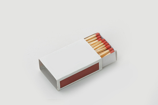 selective focus image of hand holding cigarette and full packet