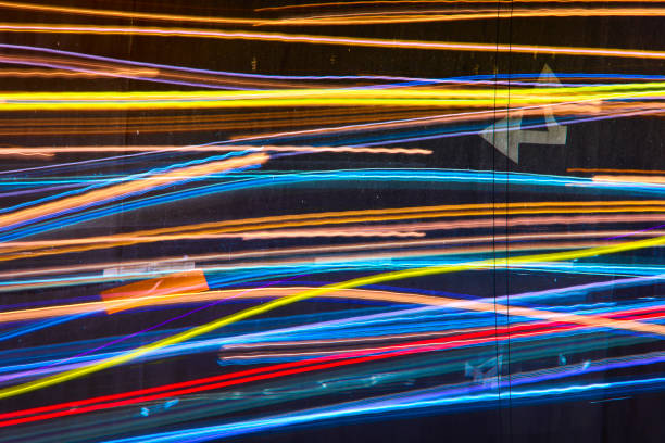 Long exposure shoot of traffic trail lighting at night in Taipei Taiwan. It makes so many abstractive color lines on the road. Top view of motion speed light in the rush hour. Including cars and motorcycles. It has multiple color and cyberpunk style.