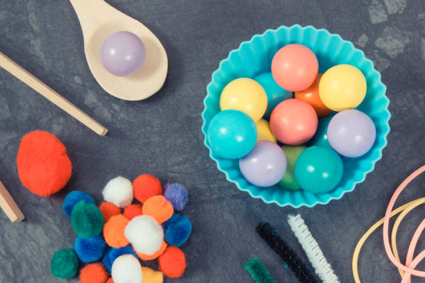 istock Colorful pompoms, balls and rubber erasers using for playing and development of kids motor skills, coordination and logical thinking 1678293848