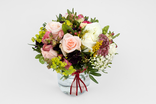 Festive arrangement with gifts and flowers on a table, top view.