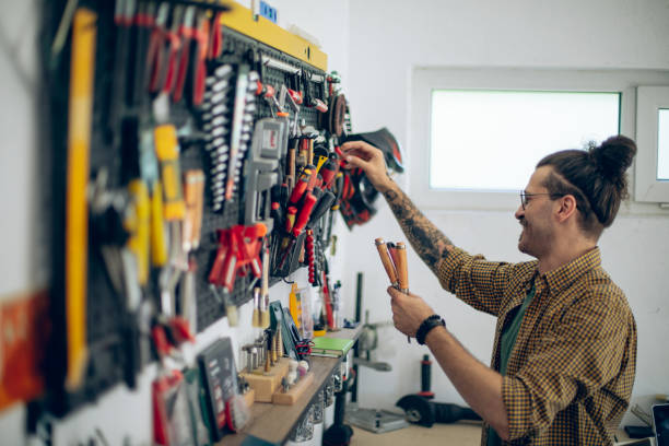 istock Craftsman taking his work tools of of wall organizer 1678304387