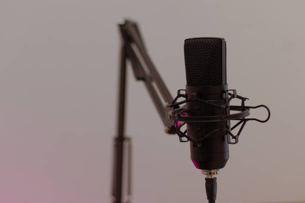 istock Black Microphone for recording a podcast. White and pink background. Close up, streaming, broadcast 1678307682