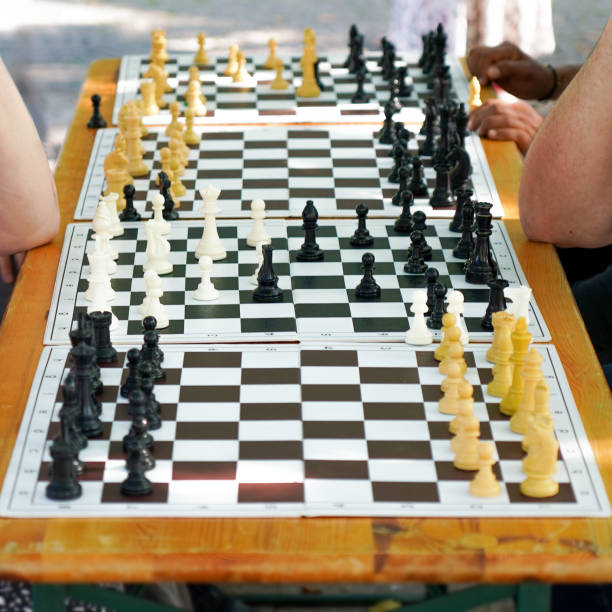 istock people playing chess in public park 1678309386