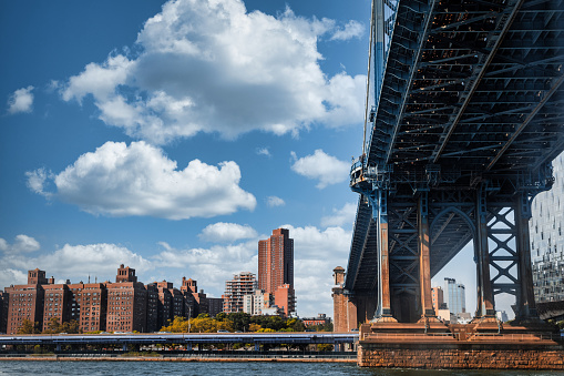 Built over the East River, the beautiful New York City Manhattan suspension bridge  spans over the East River to connect Lower Manhattan to Downtown Brooklyn.