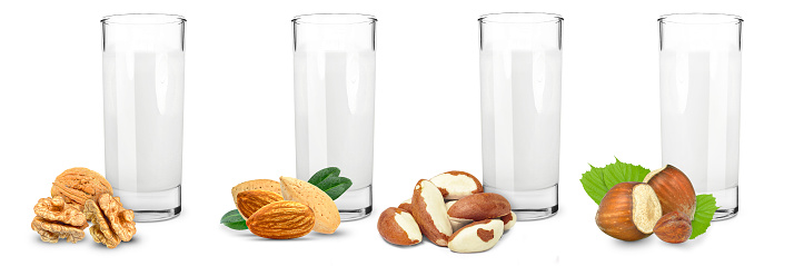 hazelnut, almond, walnut and brazil nut milk isolated on white background