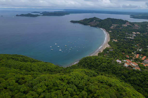 Beautiful aerial view of Playas del Coco, Hermosa Beach and its green mountains, bay and yachts in Costa Rica Beautiful aerial view of Playas del Coco, Hermosa Beach and its green mountains, bay and yachts in Costa Rica el coco stock pictures, royalty-free photos & images