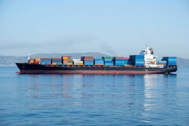 istock Container cargo ship loaded leaves Piraeus port Greece. Storage and carry. Reflection in blue sea 1678335293
