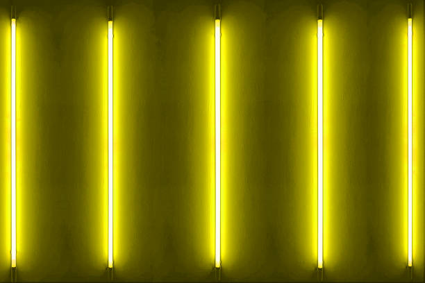 istock Five yellow neon bulbs on white wall with glowing yellow neon lights. texture background. 1678353349