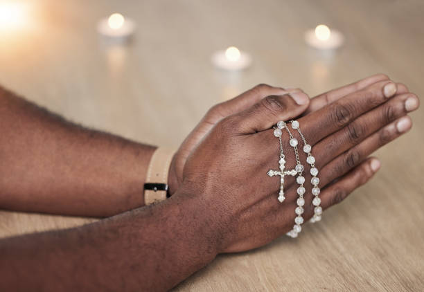 rosary, man hand and cross prayer beads in a home with hope, christian praise and religion. praying, necklace and worship in a house with god, gratitude and spiritual guide for support and healing - jesus christ human hand god consoling imagens e fotografias de stock