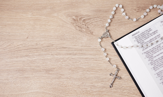 Bible, cross and religion, Christian and God with worship, studying scripture and rosary beads. Jesus Christ, prayer and spiritual, holy book and praise with healing, gospel and mockup space