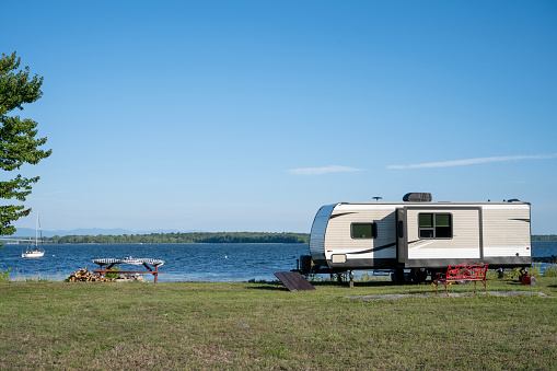 Recreational vehicle parked at a campsite on the shores of Lake Champlain
