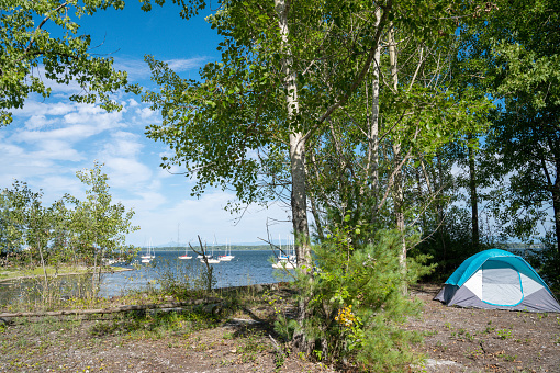 Small camping tent on the edge of Lake Champlain in summer