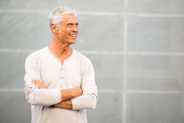 istock handsome mature man smiling with arms crossed 1678372937