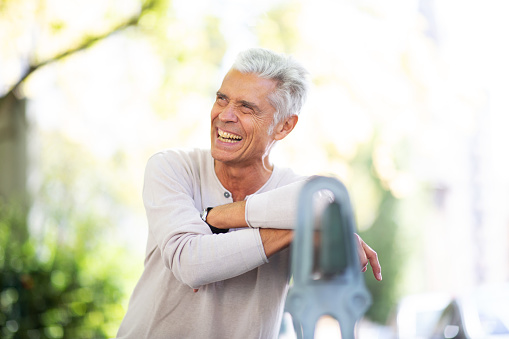 Portrait older man siting on park bench