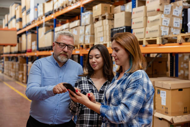 istock Smart Shopping: A customer family using a smartphone while scrolling through goods searching stock on the online shopping website or app in a retail warehouse market mall 1678381597
