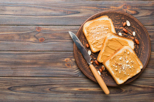 Peanut butter sandwiches or toasts on light table background.Breakfast. Vegetarian food. American cuisine top view vith copy space
