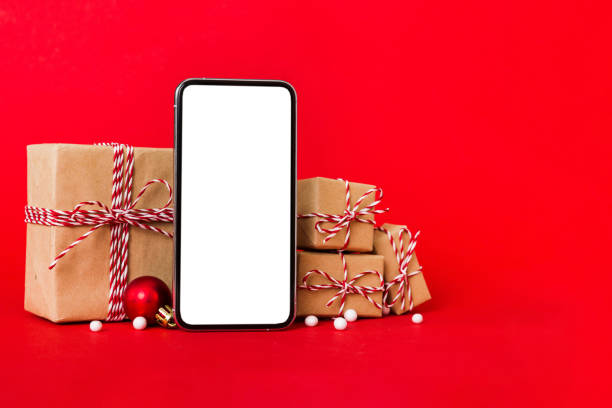 istock Digital phone mock up with rustic Christmas decorations for app presentation with empty space for you design. Christmas online shopping concept. Tablet with copy space on colored background 1678403496