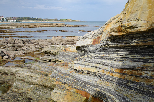 Santander, Spain - 31 Oct, 2022: Rock formations on the coast of the Magdalena Peninsula and Playa del Camello, Santander, Cantabria
