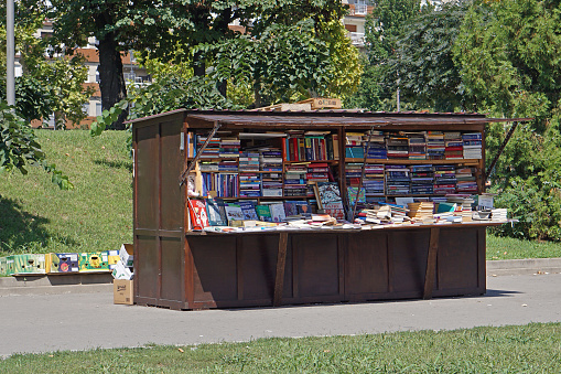 Belgrade, Serbia - August 11, 2020: Used books for sale at kiosk booth in city park summer.