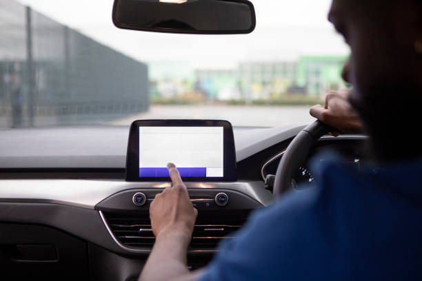 istock Close-up of hands using a touchscreen in a car 1678451360