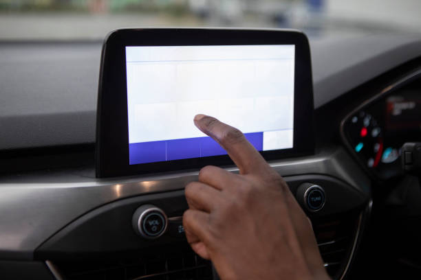 istock Close-up of hands using a touchscreen in a car 1678451393