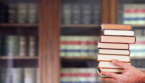 istock hands with books stacked in the library 1678471266