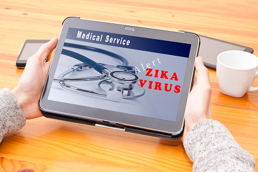 zika virus alert on the Internet at digital tablet
