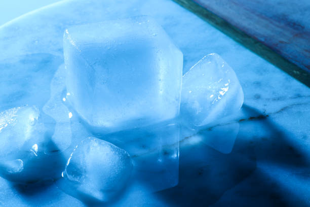 Crystal clear ice cubes on marble board, color tone effect