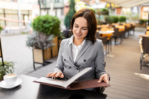 Woman reading a menu in a restaurant