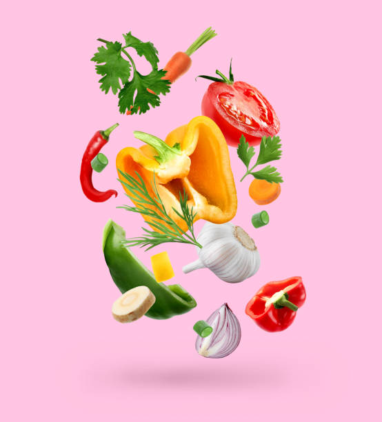 istock Spice mix for cooking. Set of falling fresh vegetables and herbs on pink background 1678484015