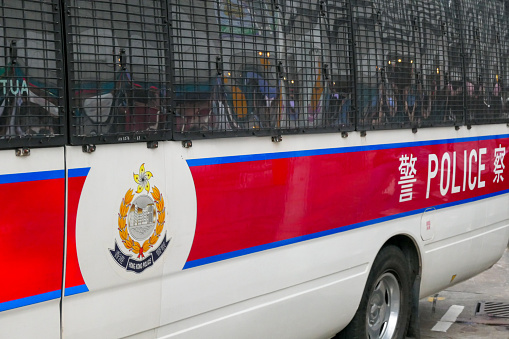 A Hong Kong Police van parked outside the Hong Kong Convention Centre in Wan Chai on Hong Kong Island.  Police officers are sitting inside the van.  The Belt and Road Summit on the Chinese Government's \