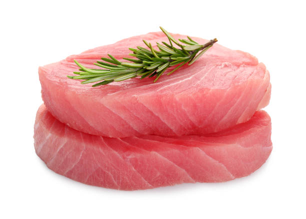 istock Raw tuna fillets with rosemary on white background 1678493219