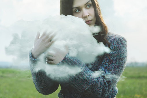 dreamy woman hugs a cloud, abstract concept