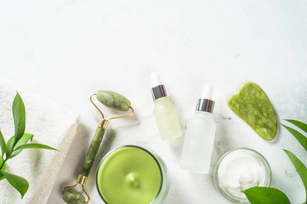 istock Jade roller and gua sha stone massager with face cream and serum bottle. 1678514147