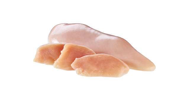 whole and sliced raw chicken breast fillet isolated on a white background. stock photo