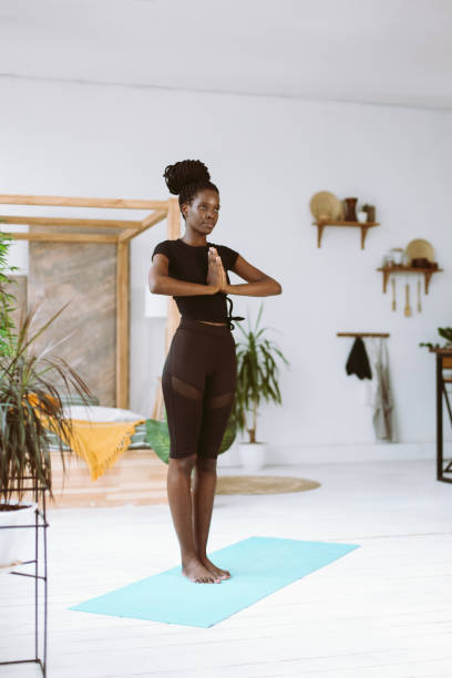 istock Vertical calm, cheerful, smiling and meditating interracial, multicultural woman practicing yoga namaste. Hope and love 1678531209