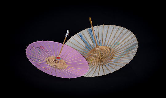 Japanese umbrella with floral pattern on black background