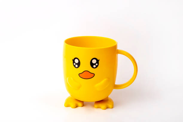 istock Yellow cup on a white background. Cup with eyes. Beautiful cup for a child. Birthday gift. 1678568773