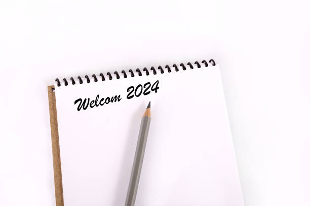 istock Text 2024 on a white background. New year 2024. Notepad and pencil on a white background. Business diary cover for 2024. planning concept 2024. 1678569179
