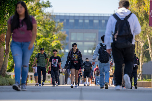 University students walk past the Natural Sciences and Mathematics build on the campus of  Cal State University Dominguez Hills, Carson, USA