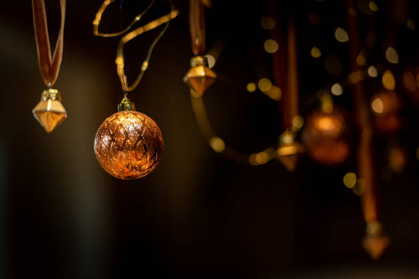 Christmas balls hang on the background of a silk curtain