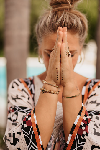 Close up of Blonde Mature Woman Praying with 