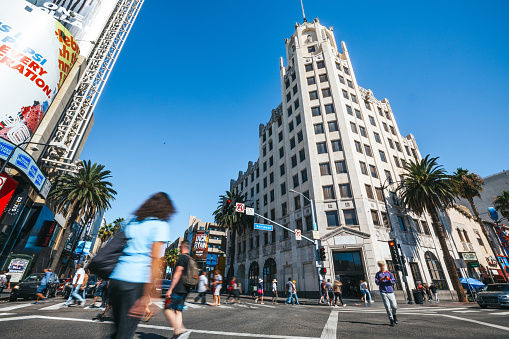 Los Angeles, CA, United States - October 19, 2023: People crossing an intersection in Hollywood Boulevard in Los Angeles.