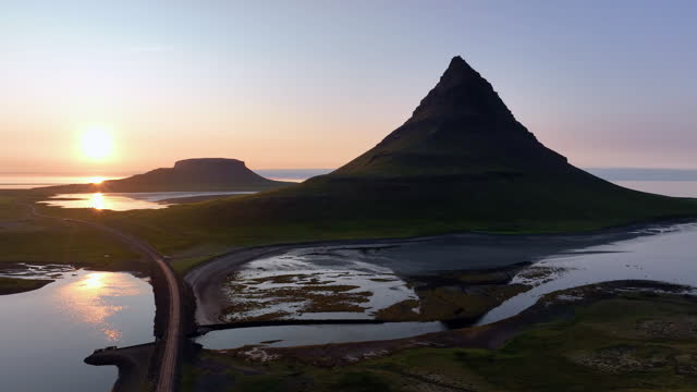 Aerial view of green mountain peak Kirkjufell is popular attractions at Iceland, Summertime trip in iceland at sunset
