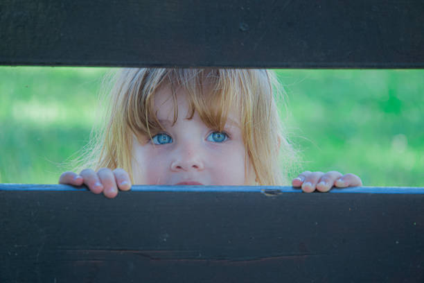 Portrait of cute baby girl with red cheeks and blue eyes.