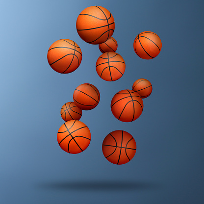 Many basketball balls falling on steel blue gradient background