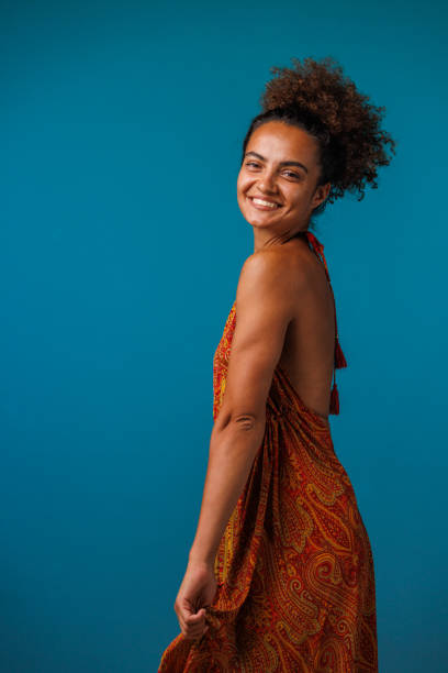 istock Charming young woman looking over shoulder, smiling at camera 1678639109