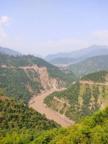 Photo of Monsoon river flowing through Mountains of Himalayas in India